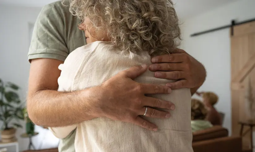 Twee nabestaanden knuffelen elkaar