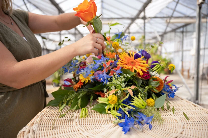 Kleurrijke bloemen worden geschikt op uitvaartmand
